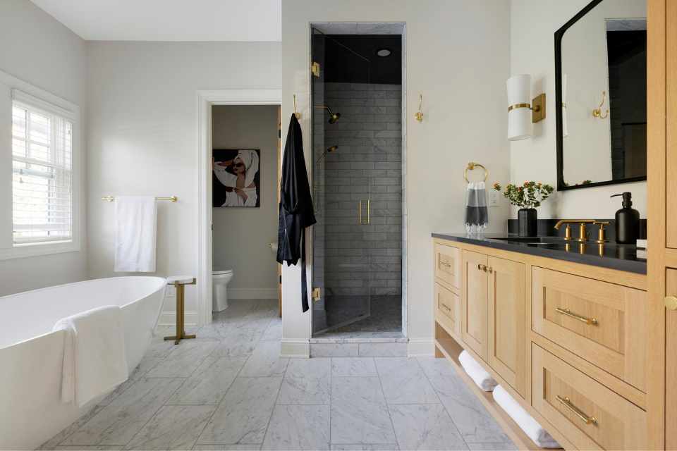 airy, natural white bathroom with wooden vanity and marble floors